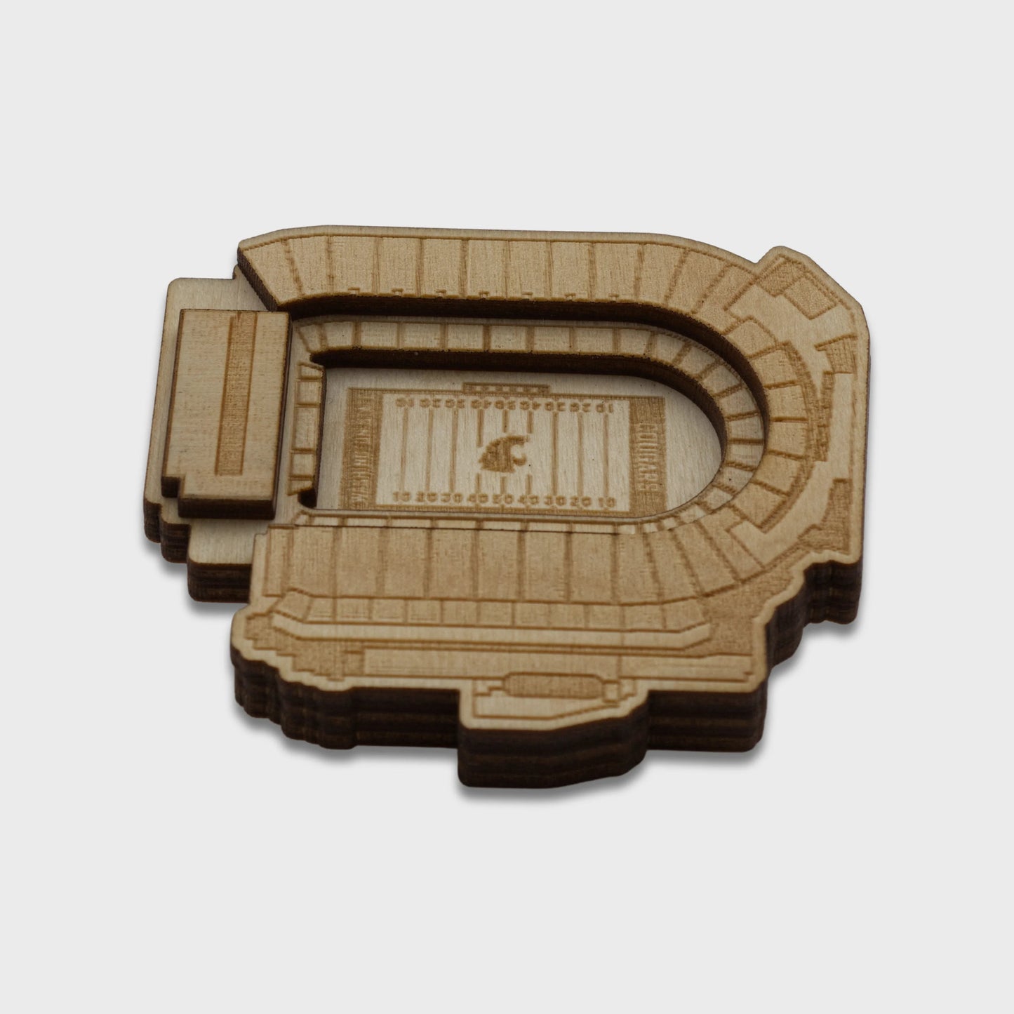 Wooden model of a stadium on a light gray background